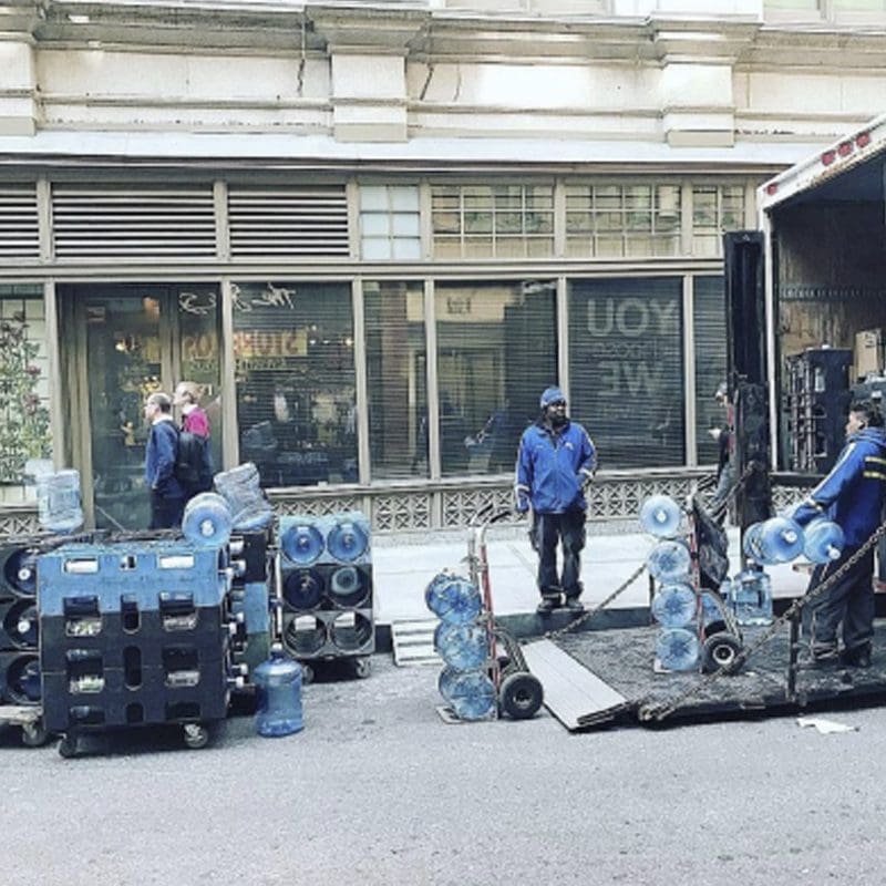 bottled water delivery Workers delivering water gallons.